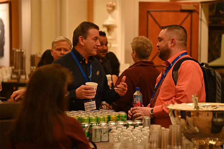Vince talking with guests at the conference