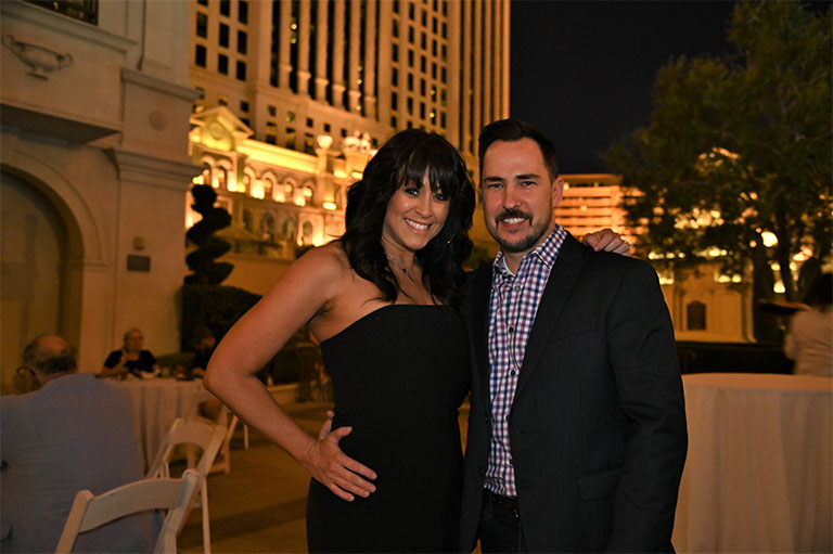 attendees posing outside Caesars Palace in Las Vegas